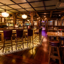 Cosy, warmly lit bar area at Scotts Hotel Killarney, featuring wooden furnishings and a welcoming ambiance.