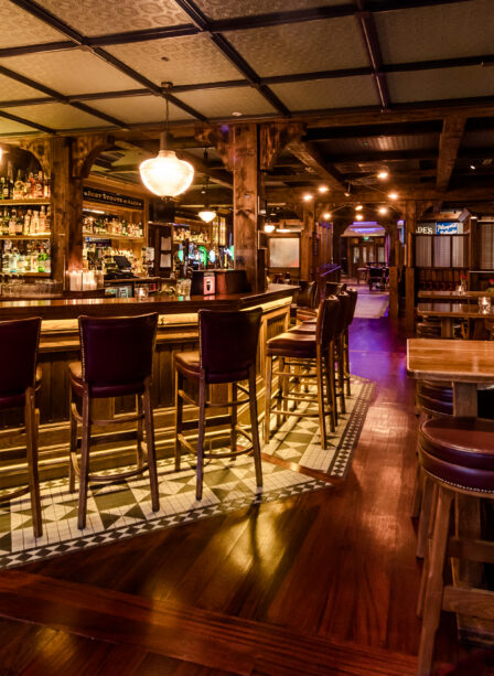 Cosy, warmly lit bar area at Scotts Hotel Killarney, featuring wooden furnishings and a welcoming ambiance.