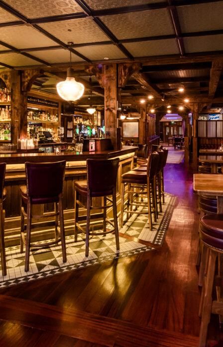 Cosy, warmly lit bar area at Scotts Hotel Killarney, featuring wooden furnishings and a welcoming ambiance.
