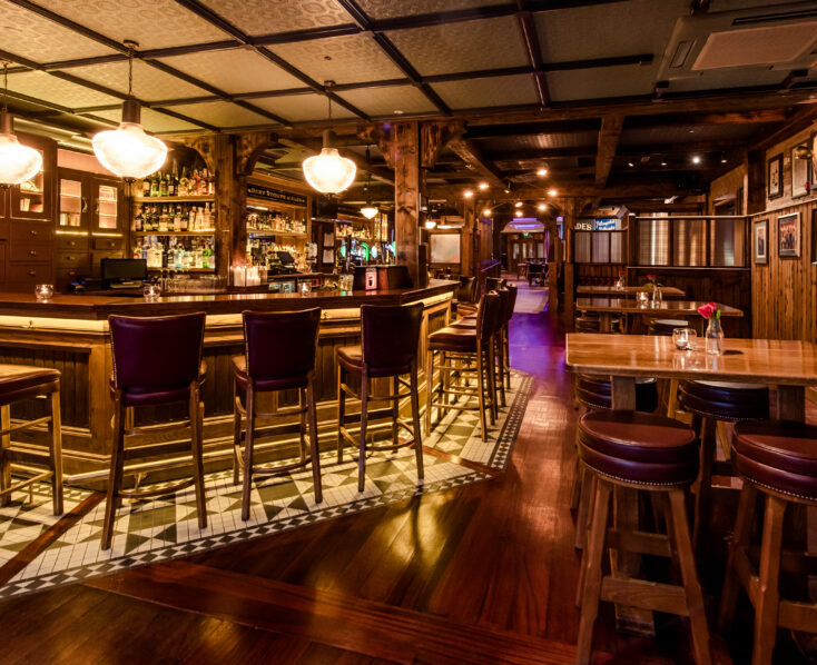 Cosy, warmly lit bar area at Scotts Hotel Killarney, featuring wooden furnishings and a welcoming ambiance.
