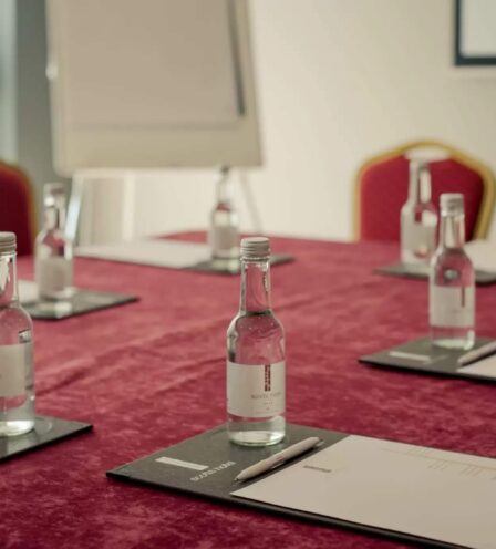 Meeting room with red chairs, notepads, and bottled water at Scotts Hotel Killarney.