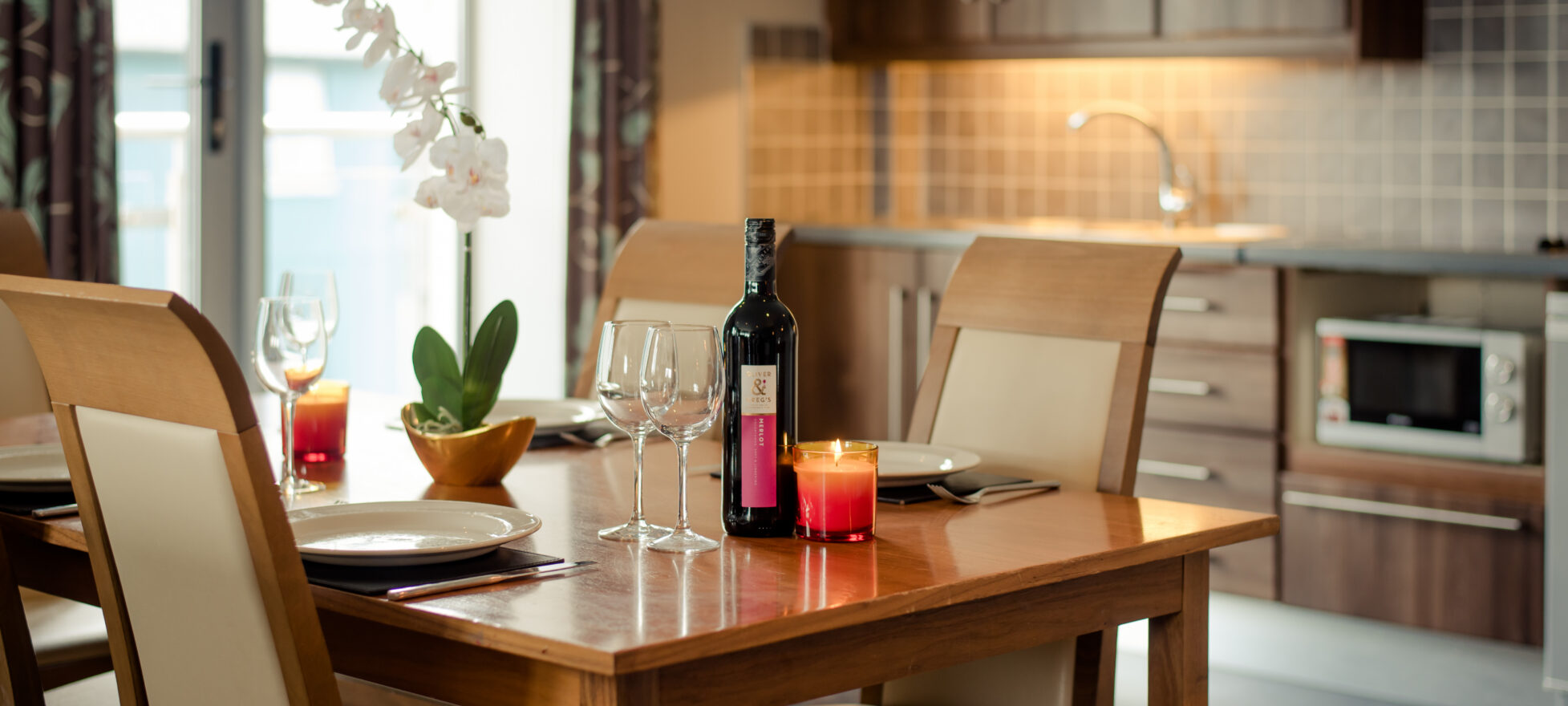 Elegant dining setup with wine, candles, and orchid in a cosy hotel room at Scotts Hotel Killarney.