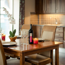 Elegant dining setup with wine, candles, and orchid in a cosy hotel room at Scotts Hotel Killarney.