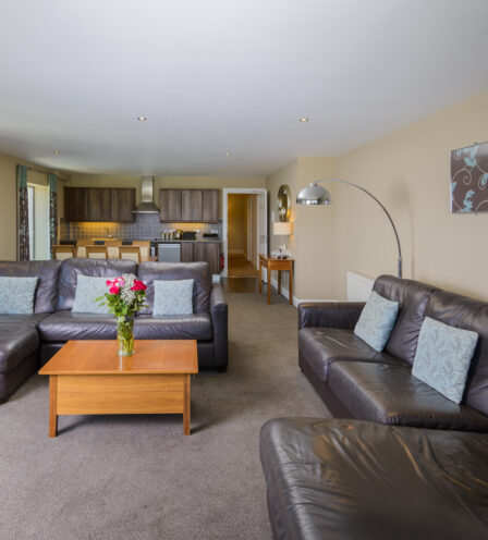 Spacious hotel suite at Scotts Hotel Killarney with cosy sofas and a modern kitchen area.