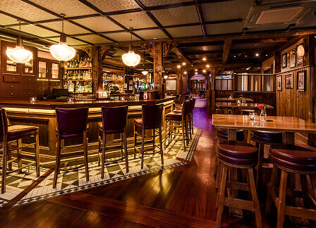 Cosy hotel bar with wooden decor, warm lighting, and plush seating at Scotts Hotel Killarney.
