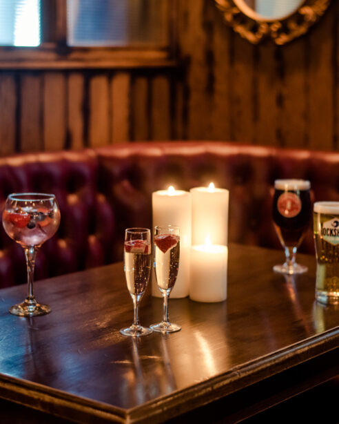 Cozy pub setting with candles and drinks at Scotts Hotel Killarney, inviting atmosphere.