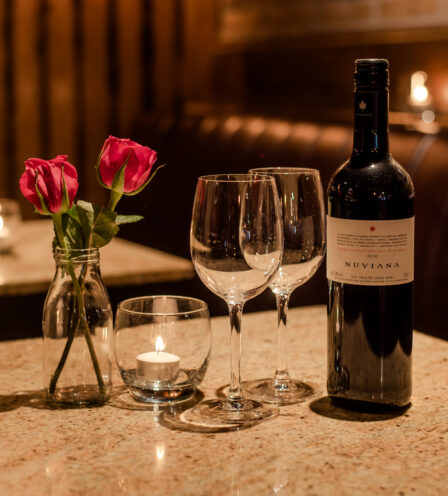 Romantic table setting with wine, flowers, and candle at Scotts Hotel Killarney restaurant.