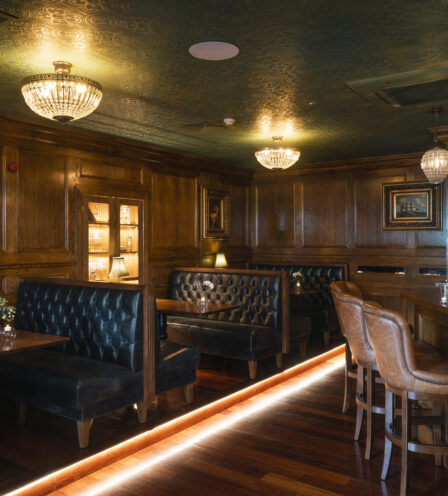 Warm, inviting bar area at Scotts Hotel Killarney with elegant seating and glowing chandeliers.