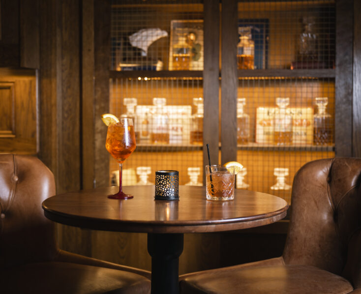 Cosy bar seating at Scotts Hotel Killarney with drinks and dim lighting creating a warm atmosphere.