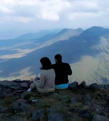 Couple enjoys panoramic mountain view in Killarney.