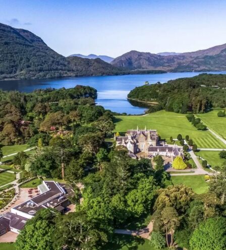 Aerial view of Scotts Hotel Killarney surrounded by lush greenery and scenic mountains.