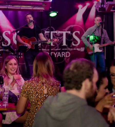 Guests enjoy live music and drinks at Scotts Hotel Killarney, creating a vibrant atmosphere.