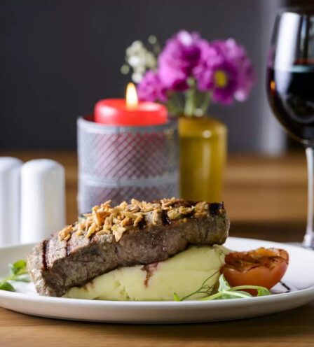 Elegant steak dish with mashed potatoes, paired with a glass of red wine at Scotts Hotel Killarney.
