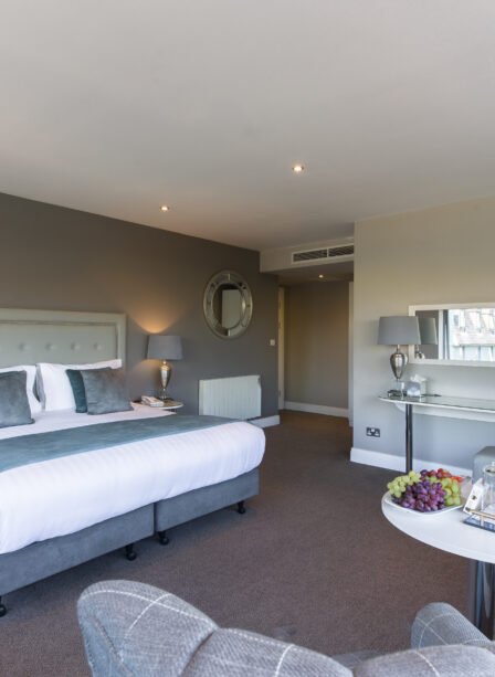 Modern hotel room at Scotts Hotel Killarney with cosy seating and elegant decor.