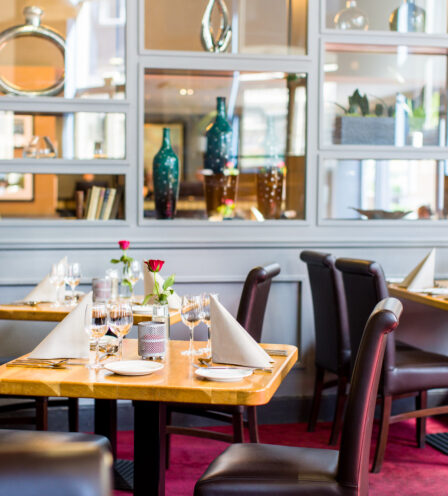 Elegant dining area with neatly set tables and warm decor at Scotts Hotel Killarney.
