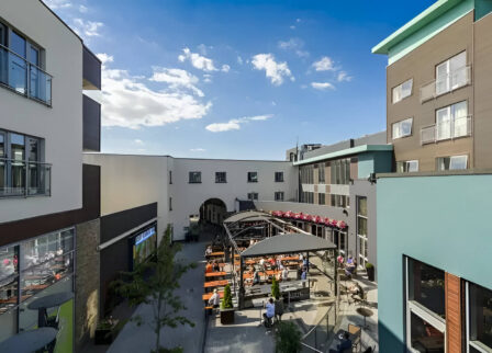 Outdoor courtyard at Scotts Hotel Killarney with guests dining under umbrellas on a sunny day.