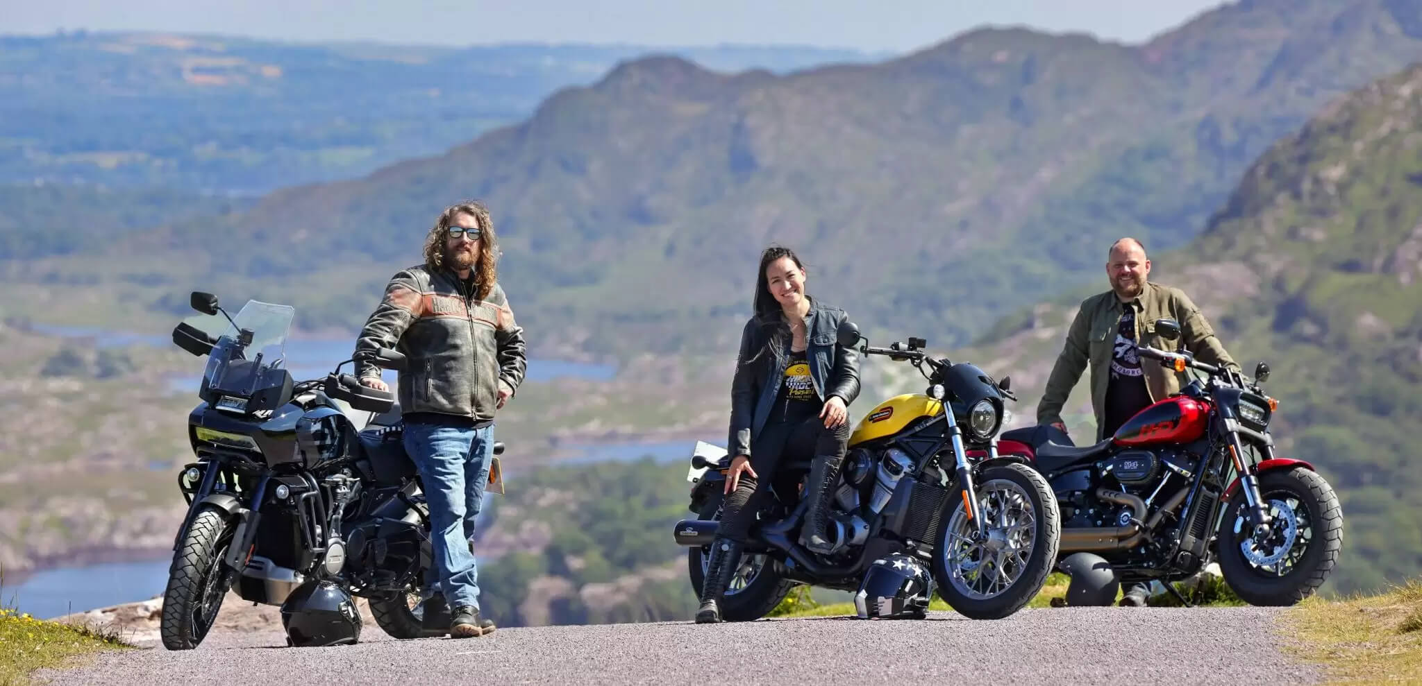 Three people on motorcycles enjoying a scenic mountain view near Scotts Hotel Killarney.