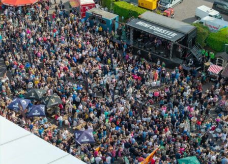A lively outdoor festival at the Glenagle Hotel Killarney with a large crowd enjoying music and food.