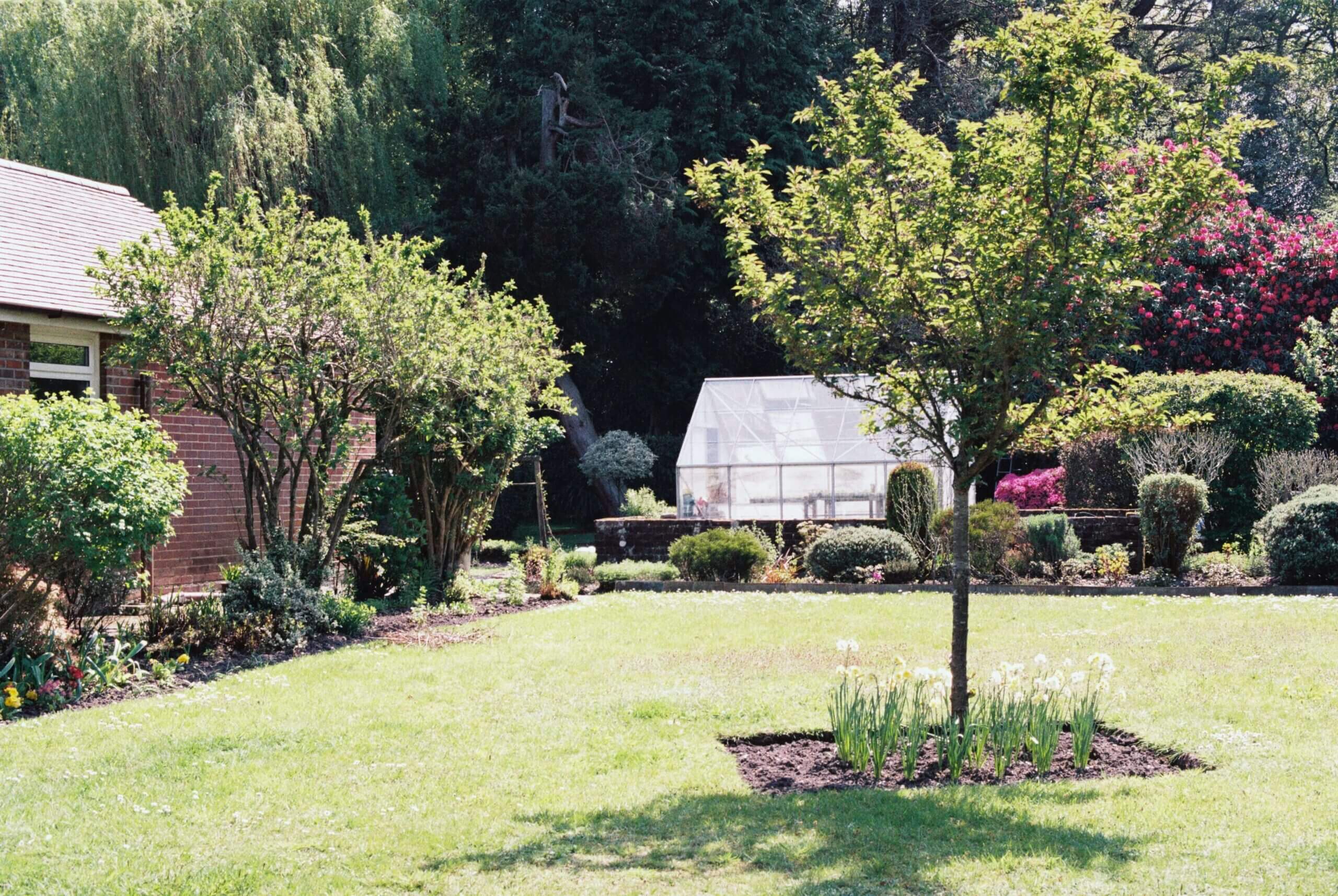 Lush garden with greenhouse and blooming flowers at Scotts Hotel Killarney.