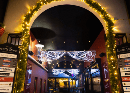 Festive entrance at Scotts Hotel Killarney with illuminated arch and elegant décor.