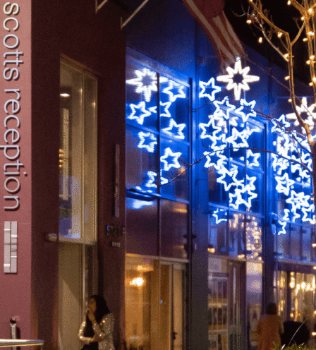 Festive entrance of Scotts Hotel Killarney with starry lights and warm, inviting decor.