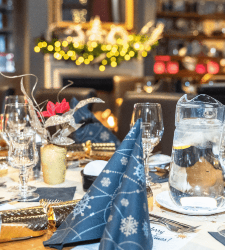 Elegant table setting at Scotts Hotel Killarney, featuring festive decor and sparkling glassware.