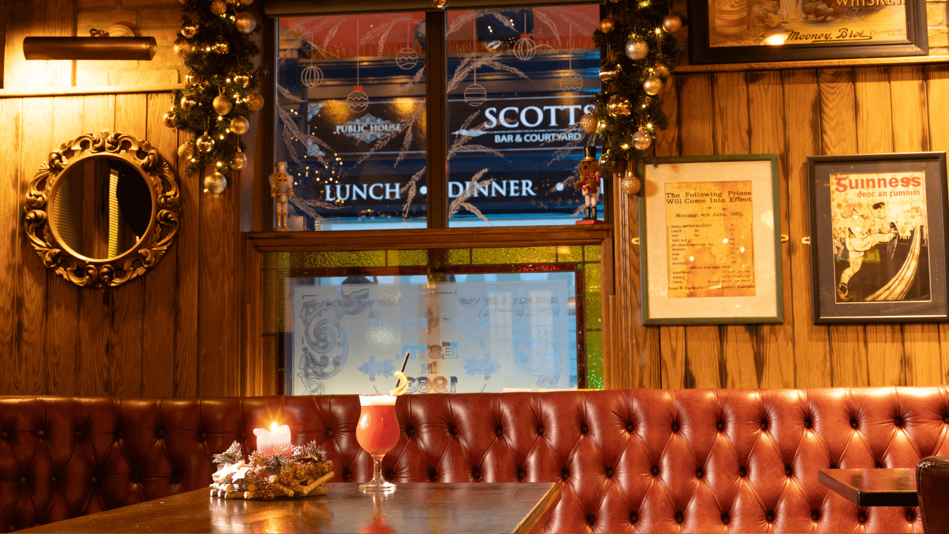 Cosy pub corner with festive decor and vibrant cocktail at Scotts Hotel Killarney.