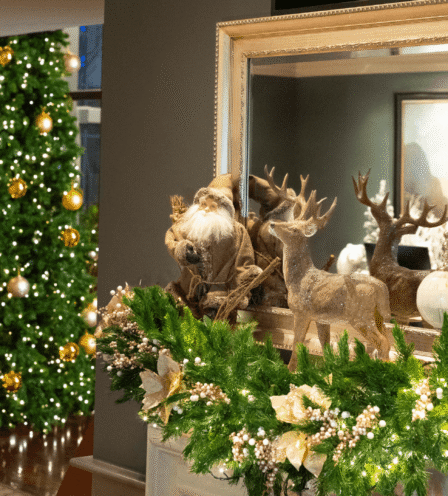 Festive hotel lobby with Christmas decorations and a lit tree.