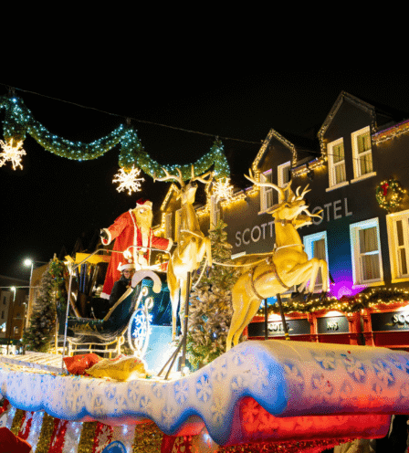Festive crowd enjoying Christmas lights at Scotts Hotel Killarney, with a vibrant holiday parade.