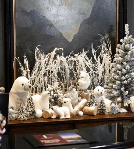 Festive hotel reception display with plush polar bears, snowy trees and winter decor, front desk visible